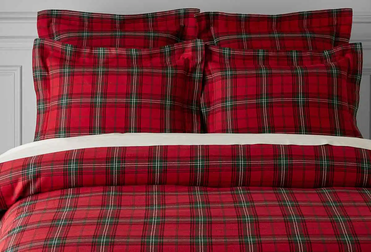 Red plaid sheets and pillows on bed