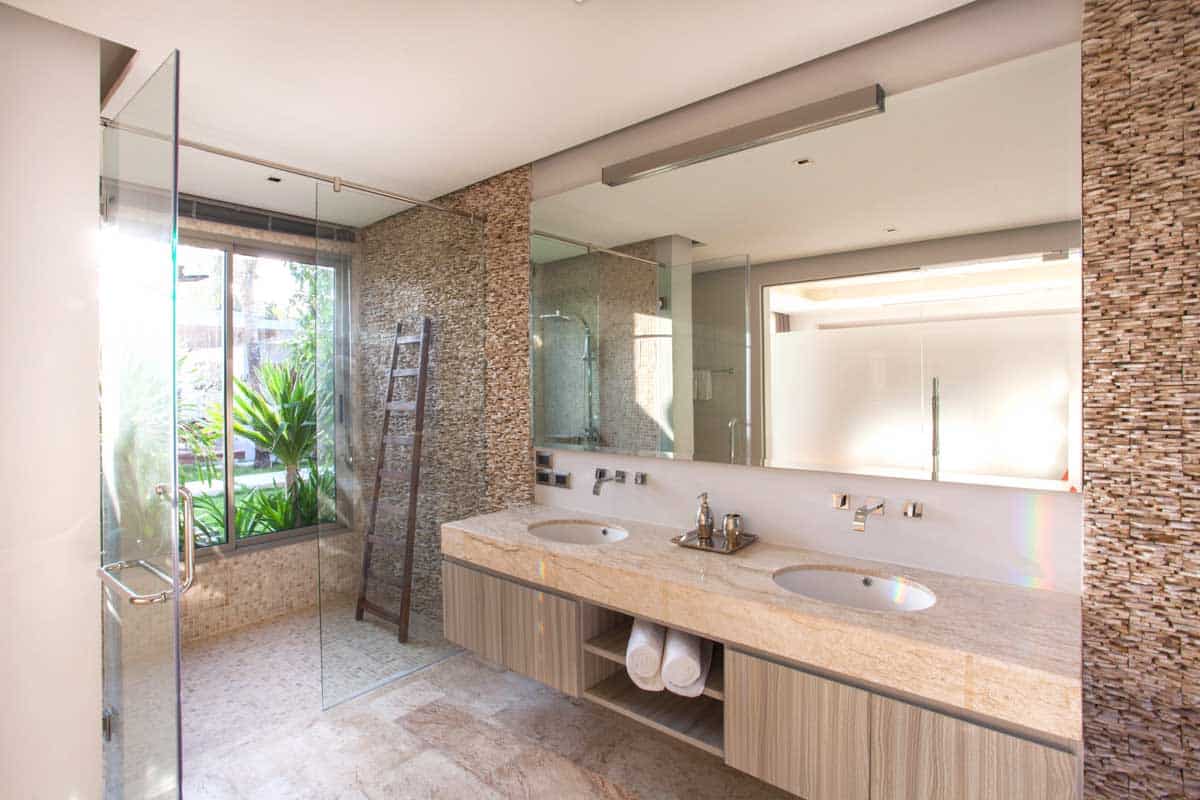 stone mosaic bathroom with vanity area and shower
