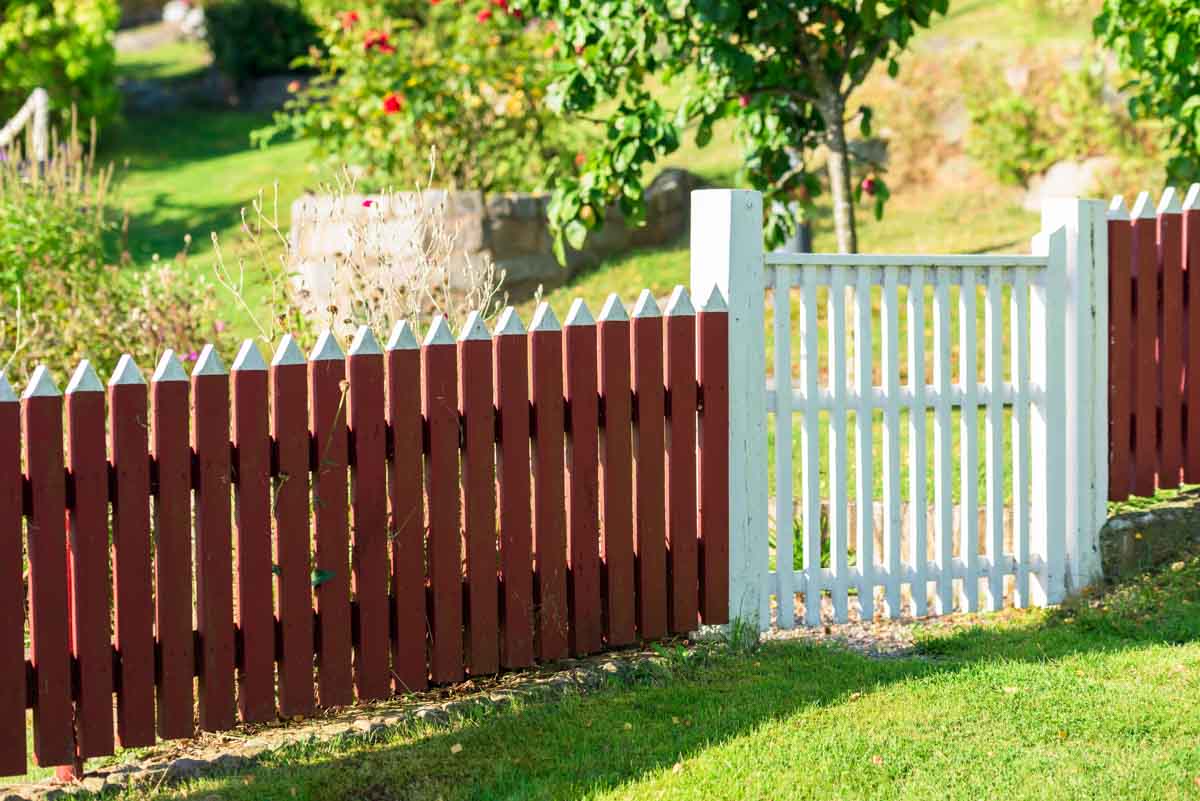 barn red fence with white gate