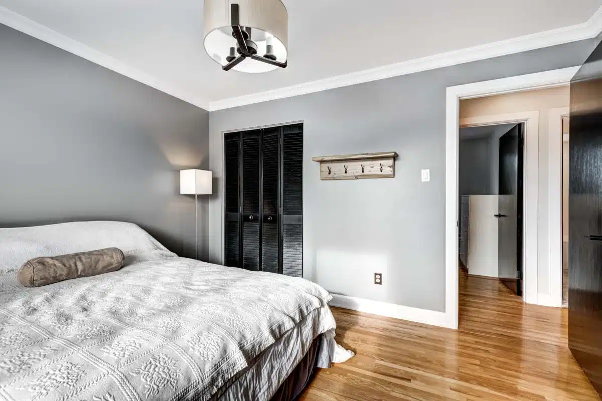 basement bedroom suite with ceiling light and black door