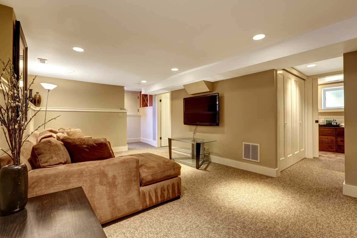 basement space with suite for in laws cream walls and television