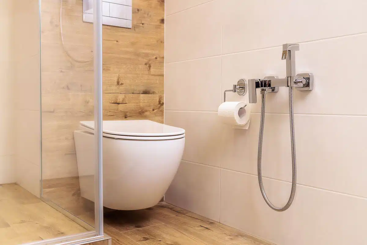 bathroom with wood wall and toilet