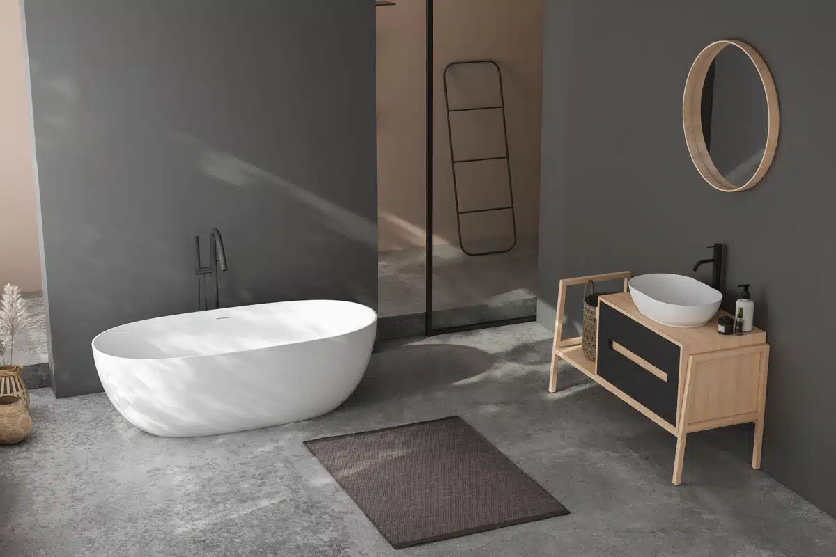 gray bathroom with rug sink mirror and bathtub