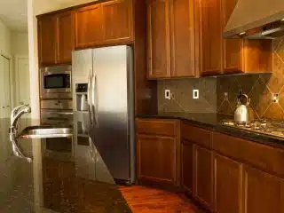 kitchen with cabinets tile backsplash and refrigerator