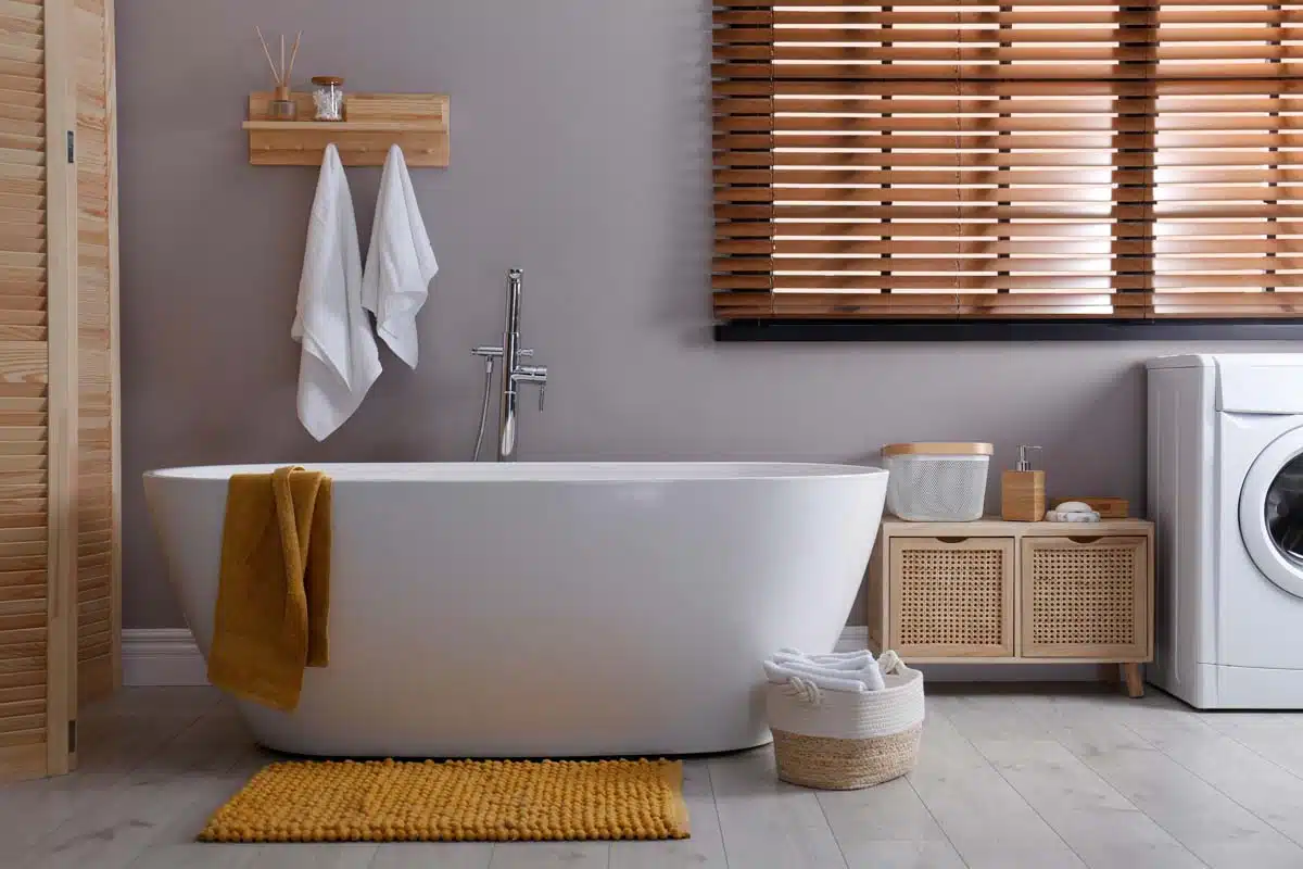 simple bathroom with bathtub chenille rug and window blinds
