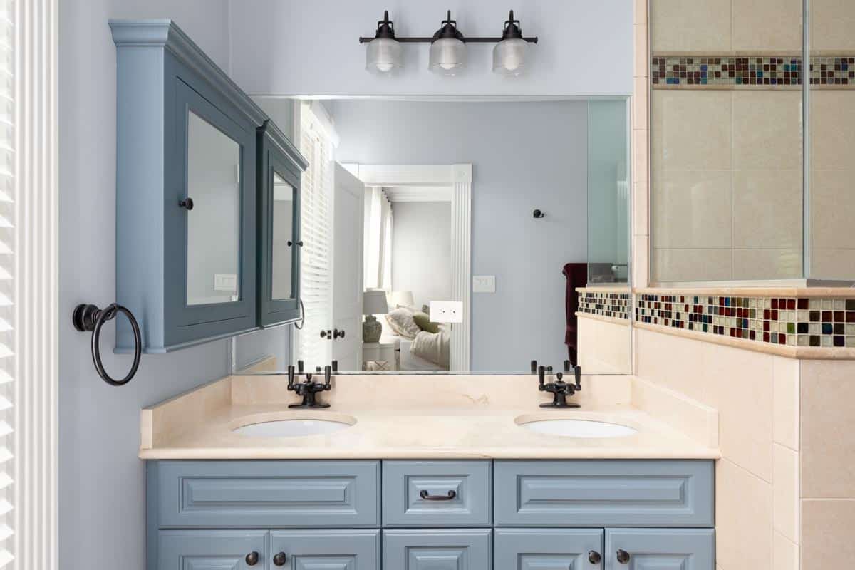 bathroom with blue cabinets faucet and sink