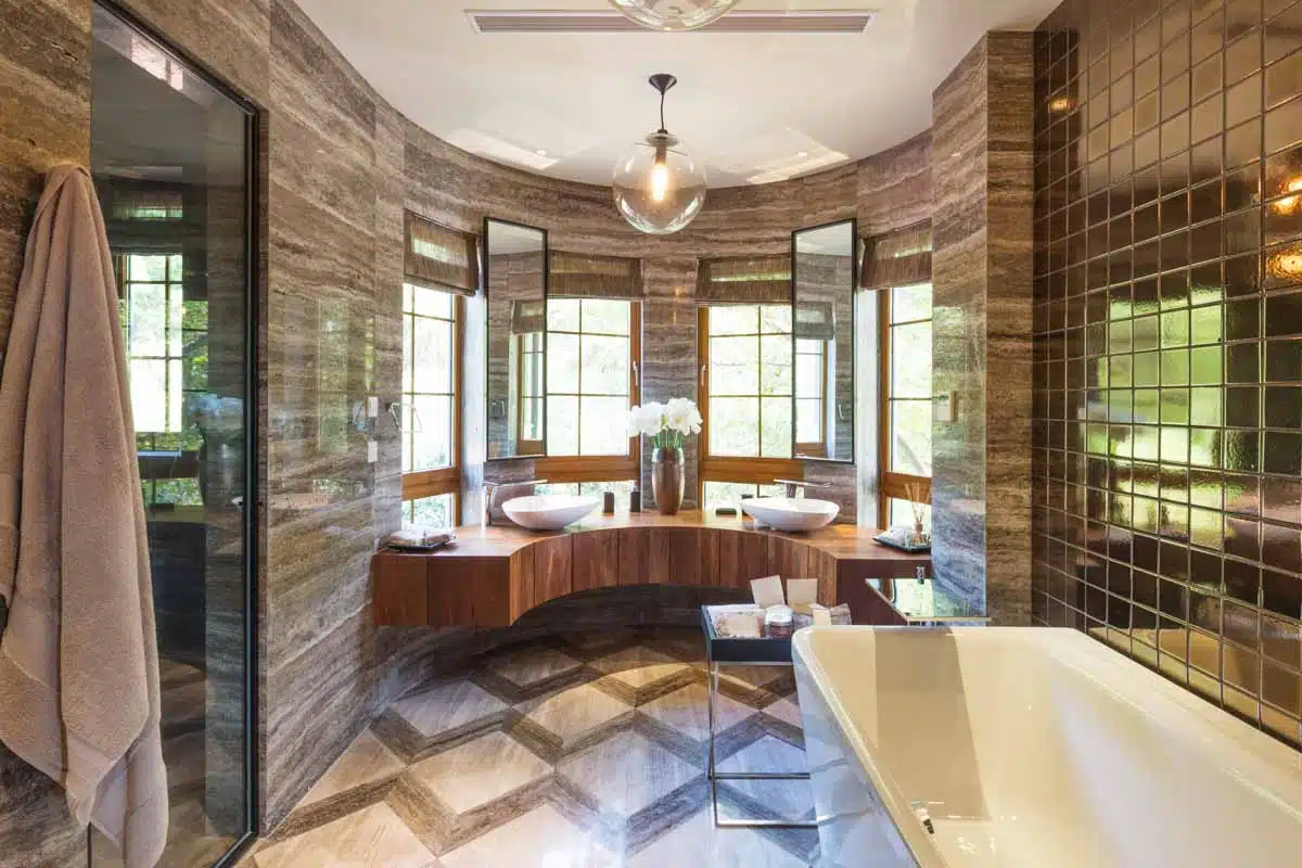bathroom with curved vanity windows and tile walls