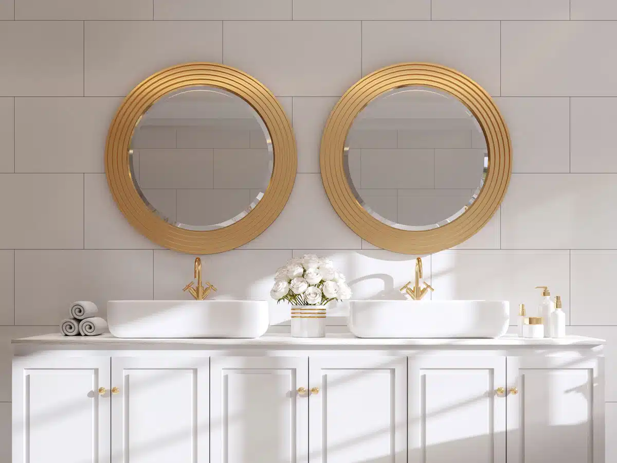 bathroom with dual mirrors and tile backsplash