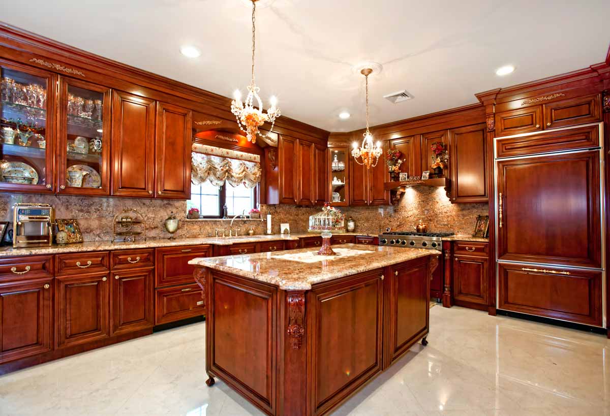 beautiful kitchen with chandeliers and tan floors