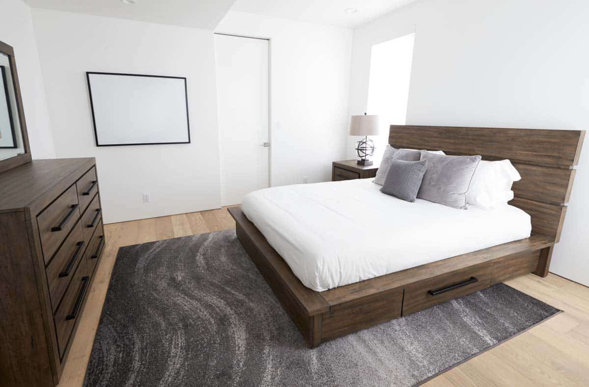 bedroom with headboard bedsheet and dresser