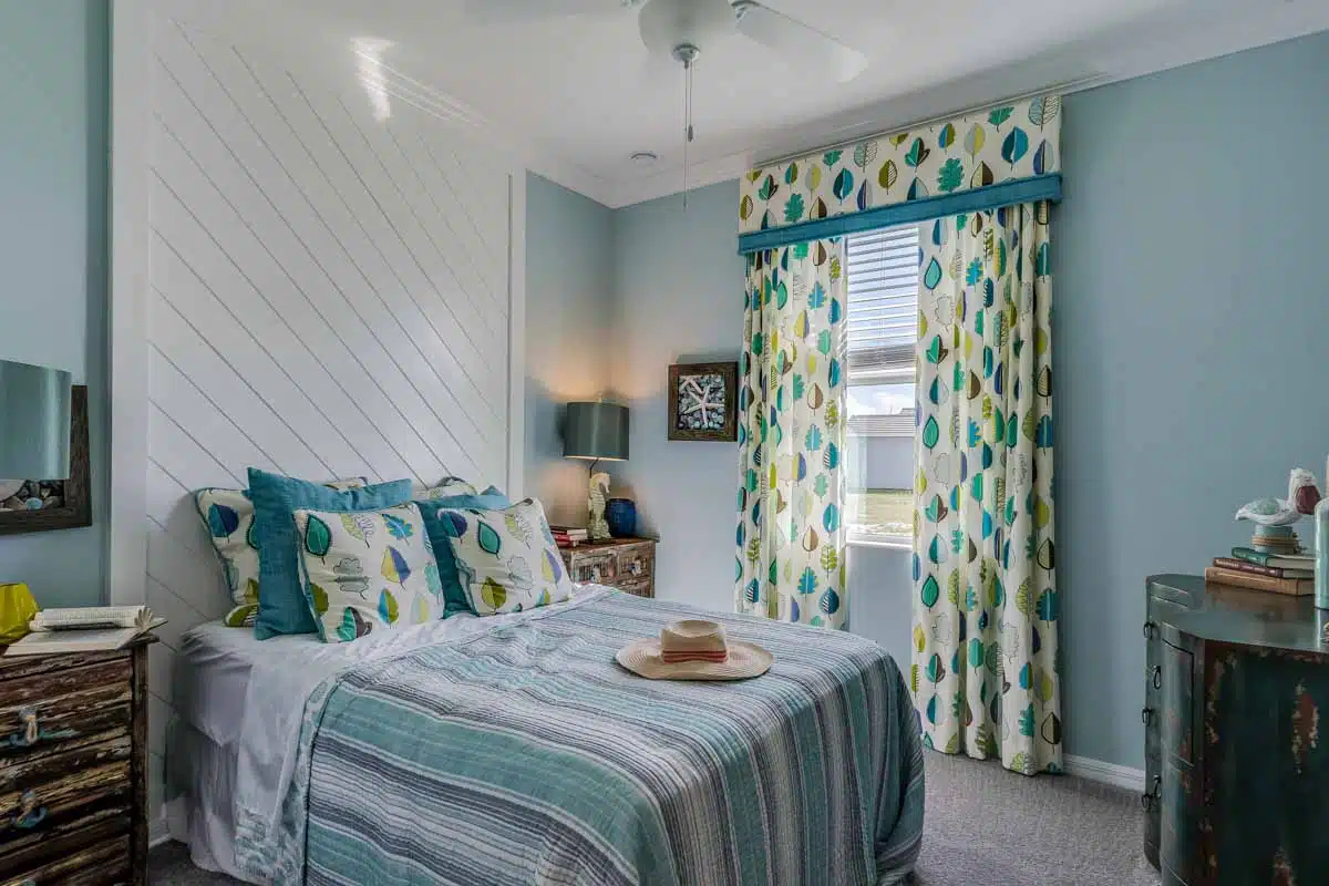 bedroom with shiplap accent wall and curtains