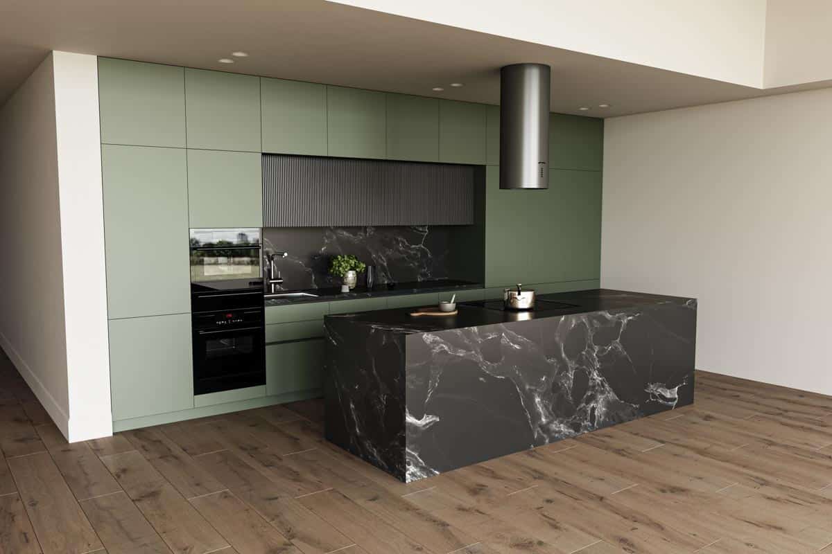 black island in kitchen with green cabinets