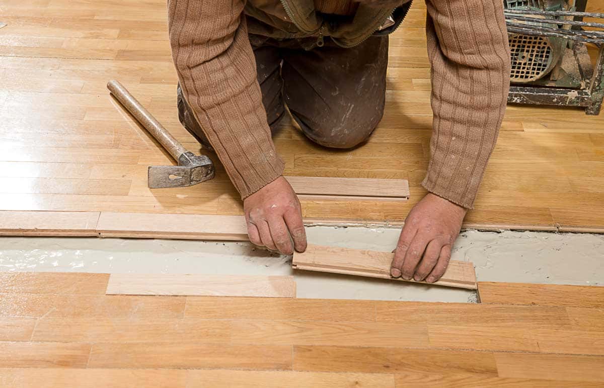 contractor installing laminate floor