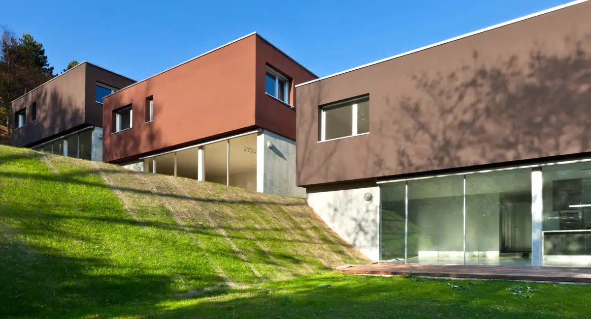 house with grassy slope