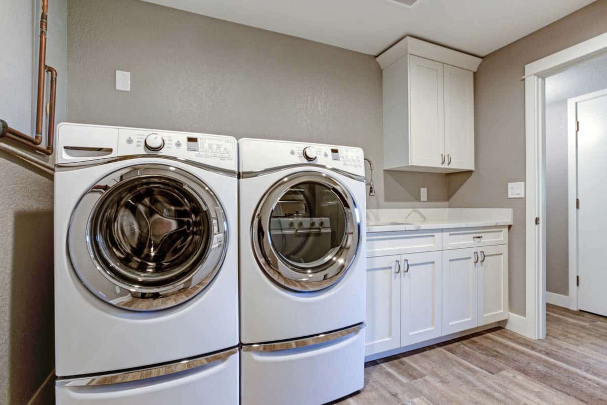 laundry space with countertop cabinets and pedestals