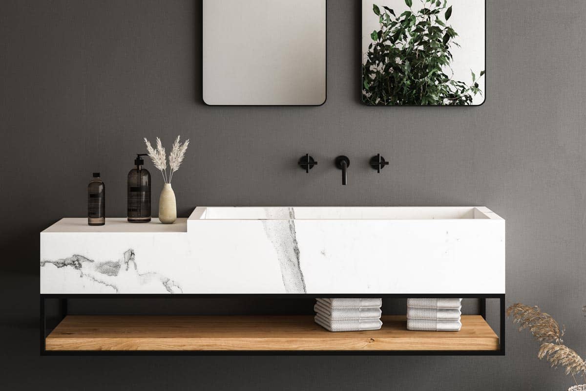 marble counter in bathroom with wall mounted faucet