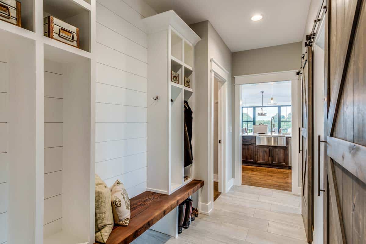 mudroom with wall made of shiplap and bench