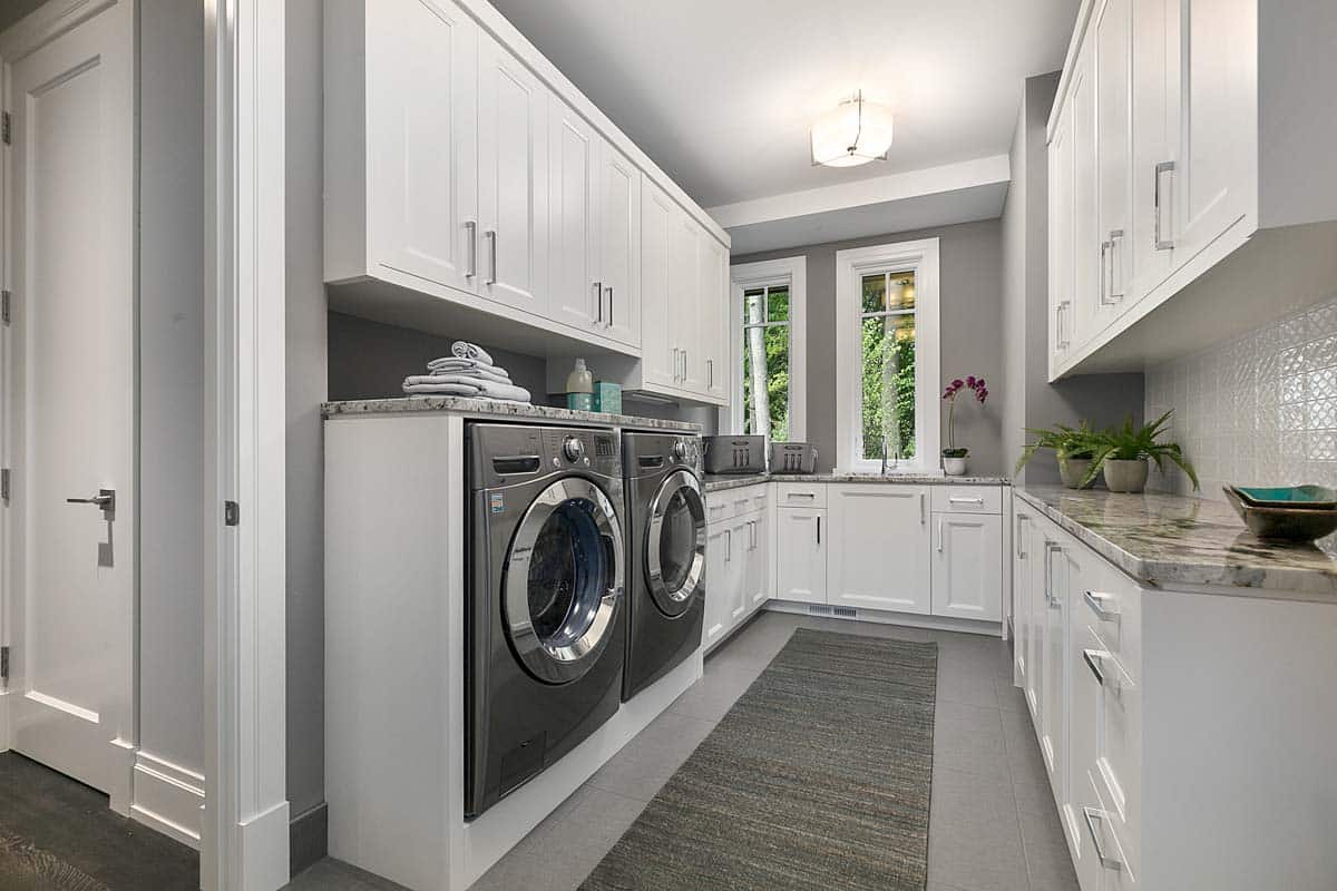 room for laundry with windows and cabinets