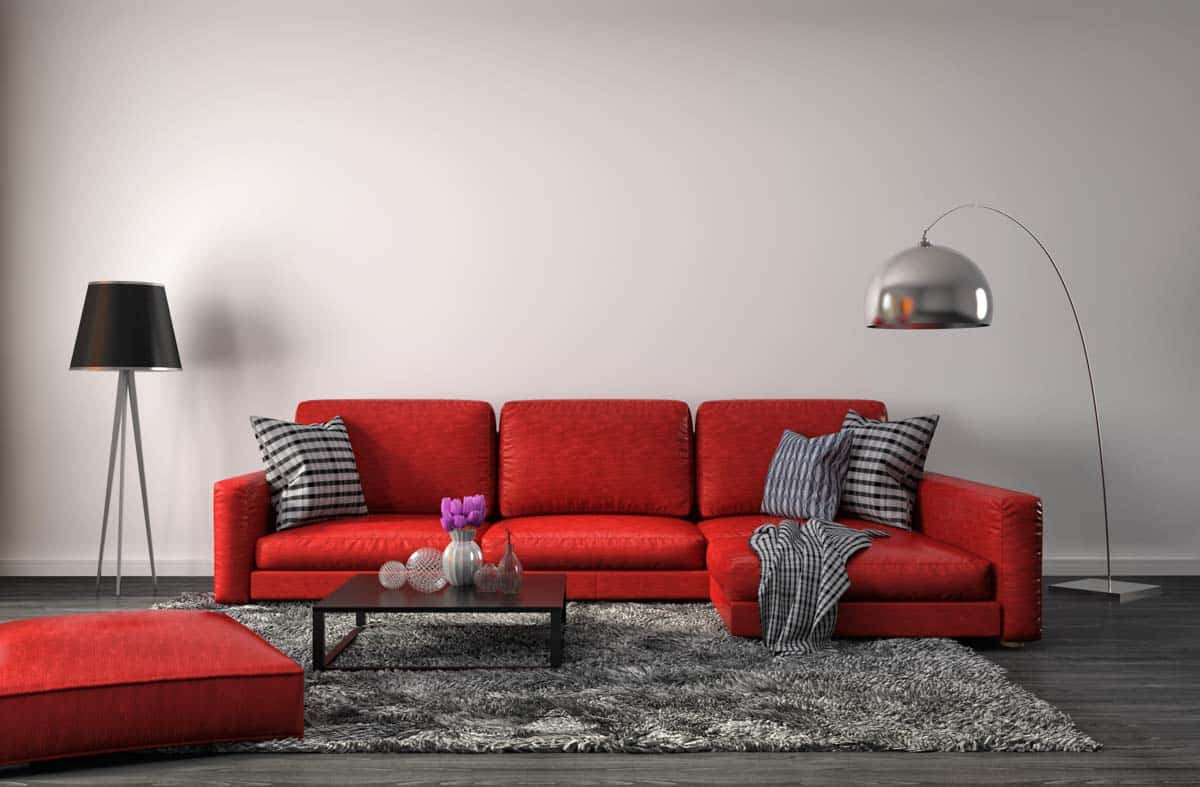 room with red colored couch lamps and rug