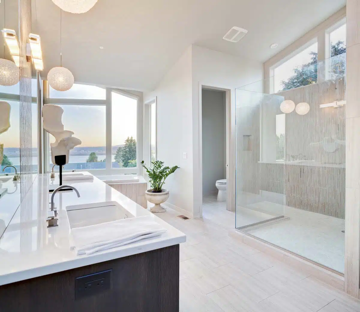 white bathroom with countertop and shower