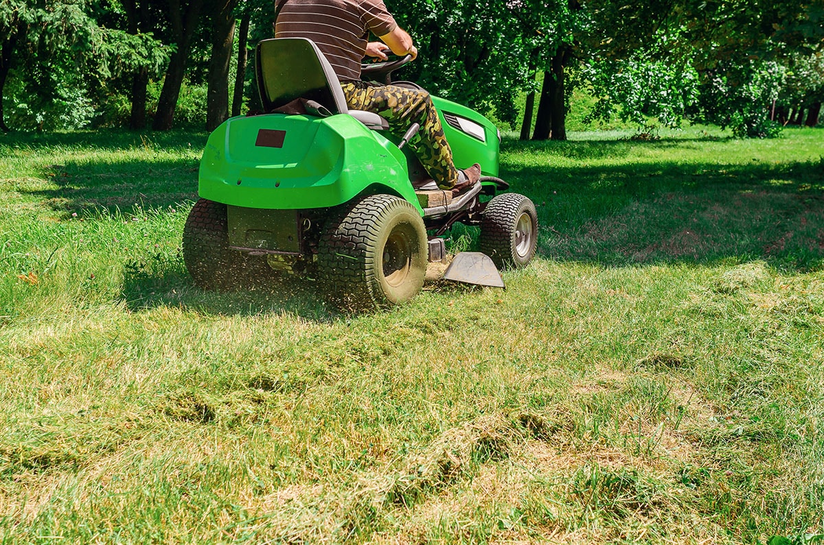 Tractor mower cutting grass