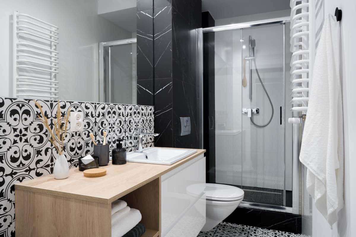 bathroom with tile backsplash and shower