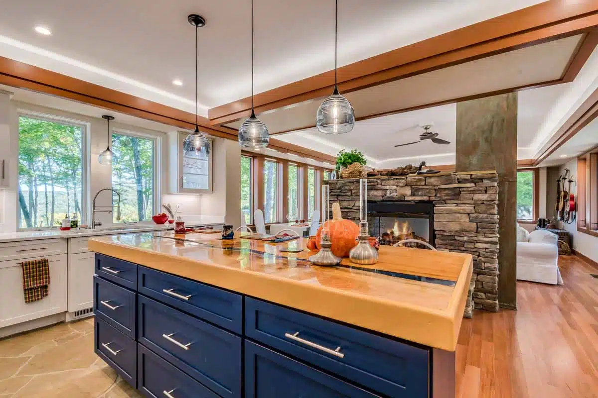 kitchen with blue island and cove ceiling