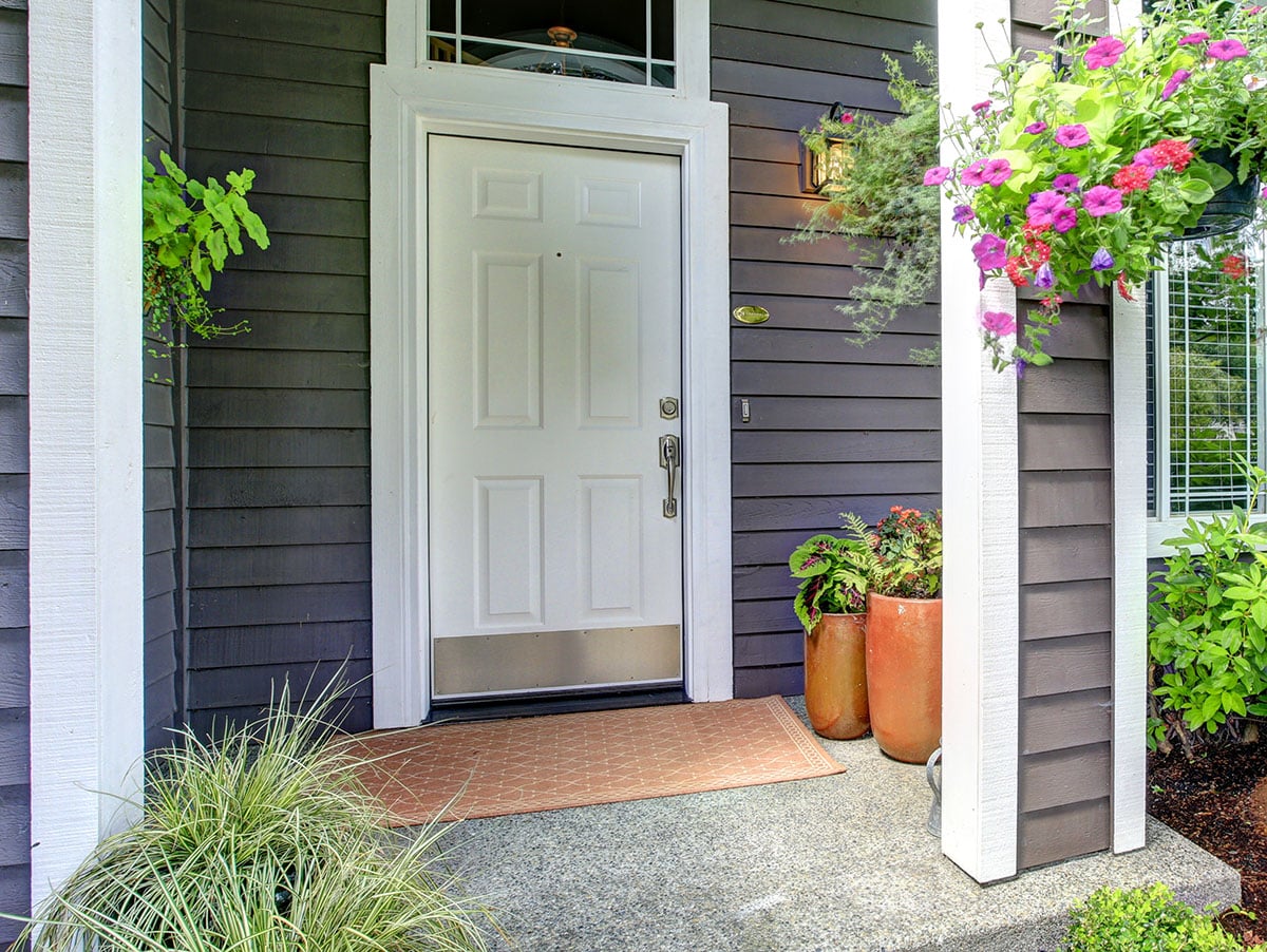 House entryway with clapboard siding white front door