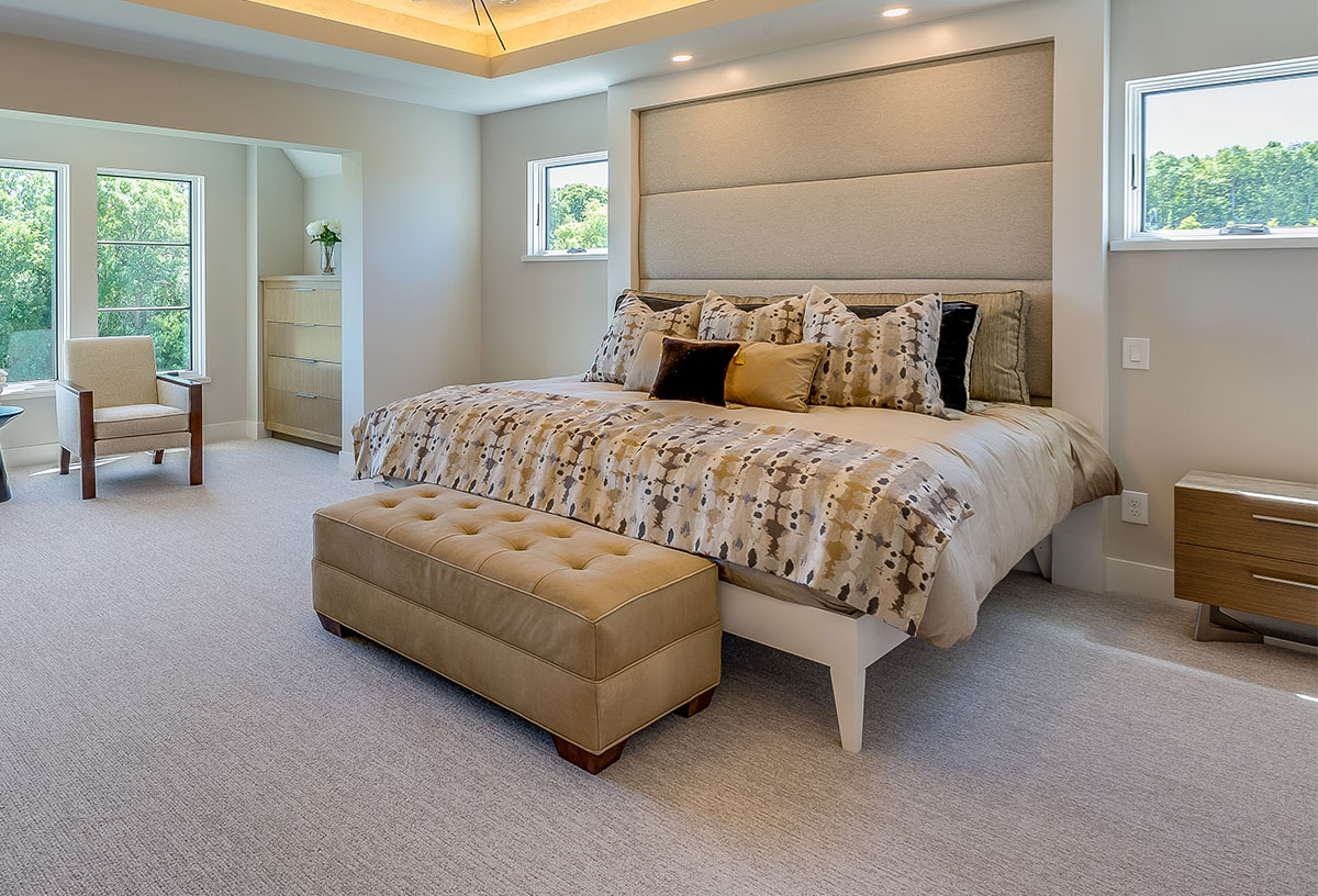 Master bedroom with indirect accent light tray ceiling platform bed bench