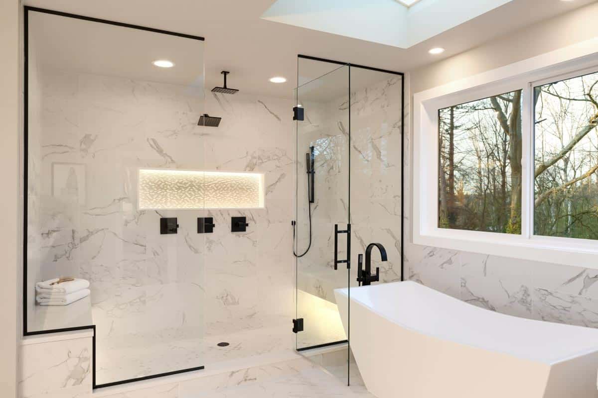 bathroom with shower tile wall glass enclosure and tub