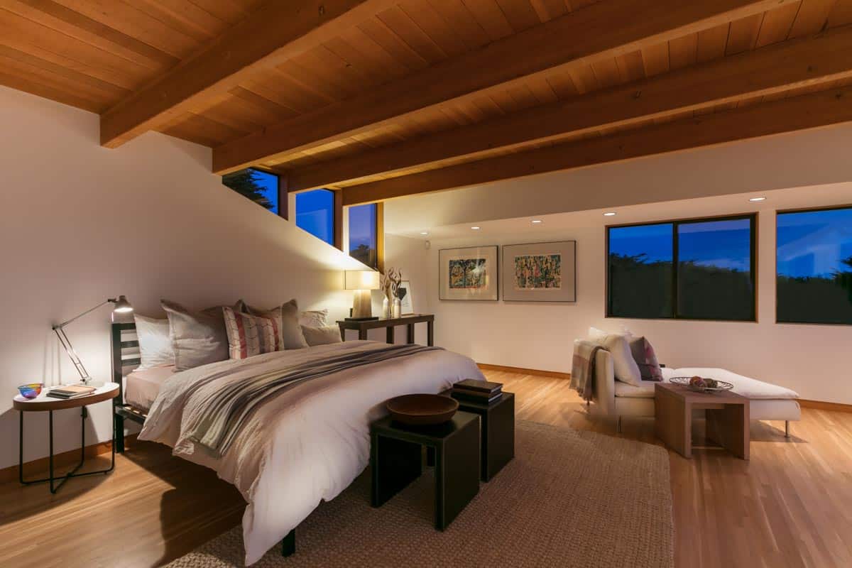 bedroom with sculpted bowl and wood ceiling beams