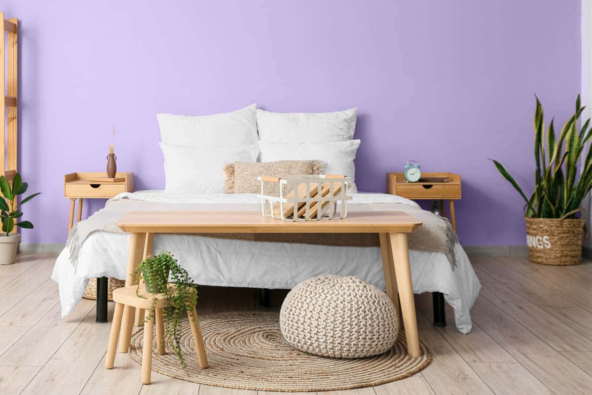 bedroom with table and purple wall