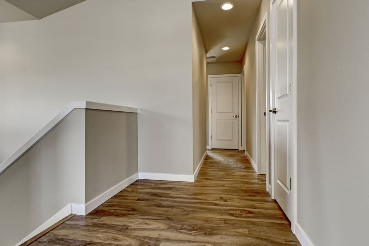 hallway area with wood flooring and beige walls