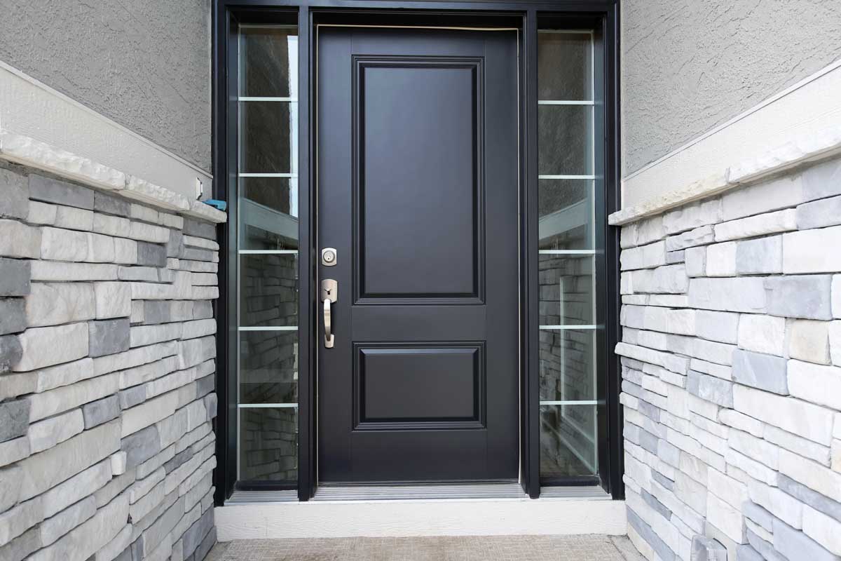house entryway with glass panels door and stone wall