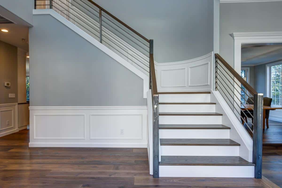 interior staircase with railing and wood flooring