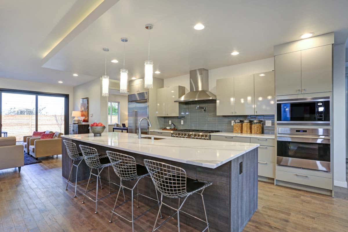 kitchen with seating pendant lights and cabinets