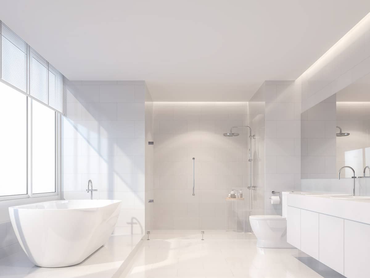 white bathroom with bathtub vanity and windows