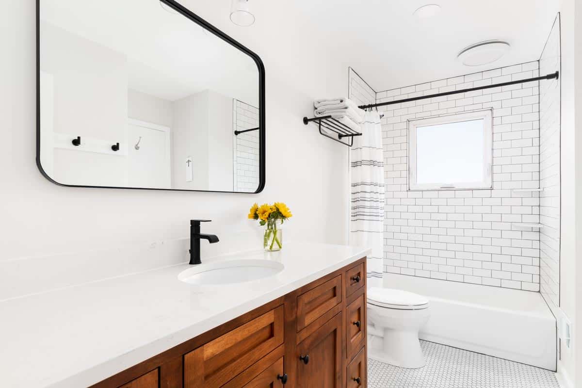 white bathroom with shower tiles
