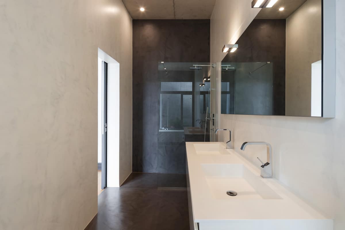 bathroom with minimalist design vanity area and shower