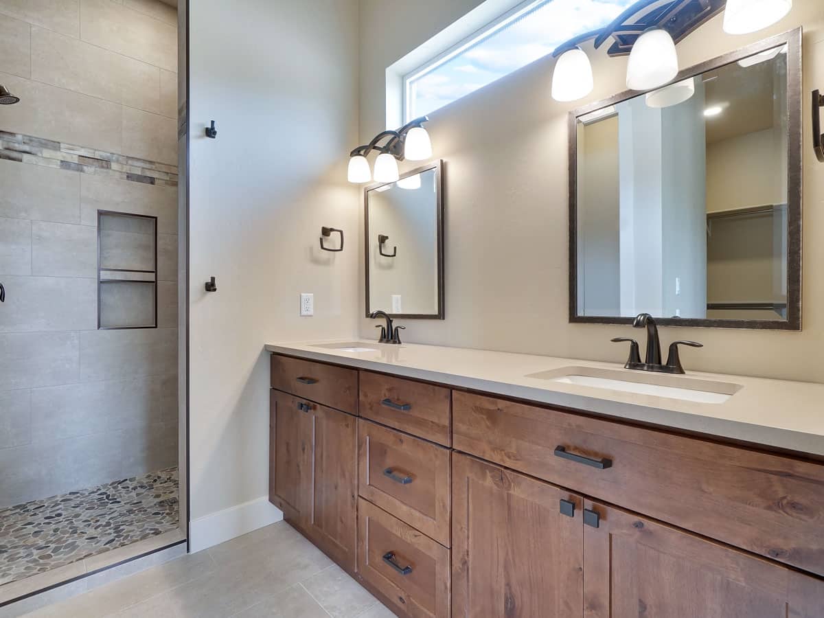 bathroom with vanity lights and wood cabinets