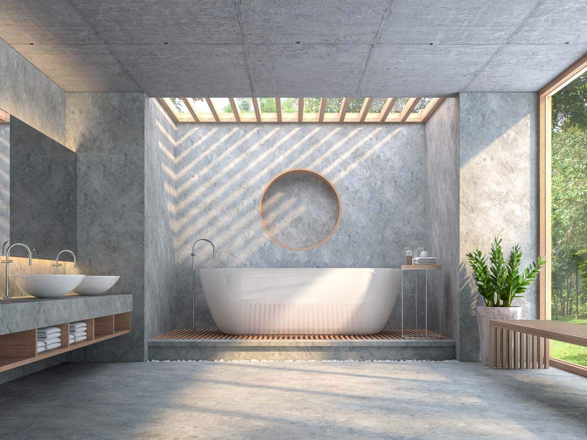 concrete bathroom with tub and skylight