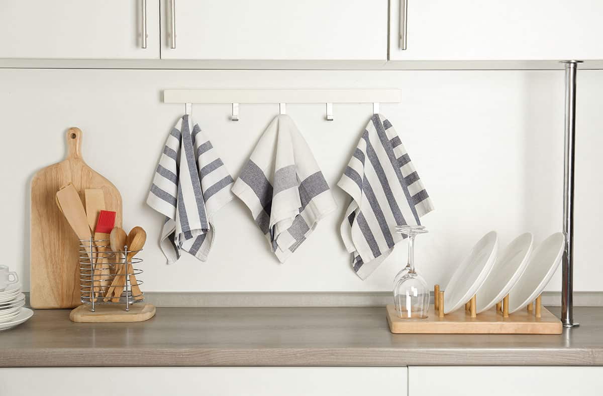 Kitchen countertop with kitchen towels wooden spoons and serving plate organizer