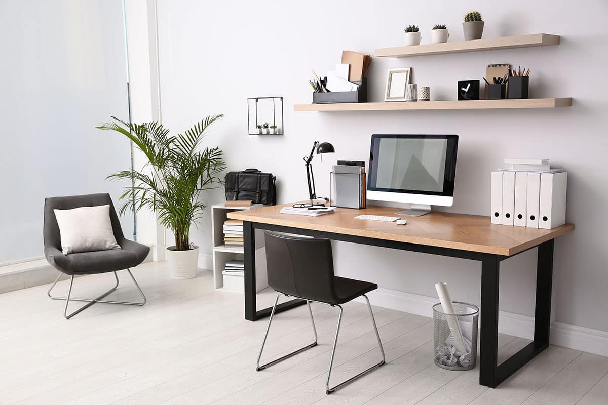 Home office with white paint modern desk floating shelves working lamp