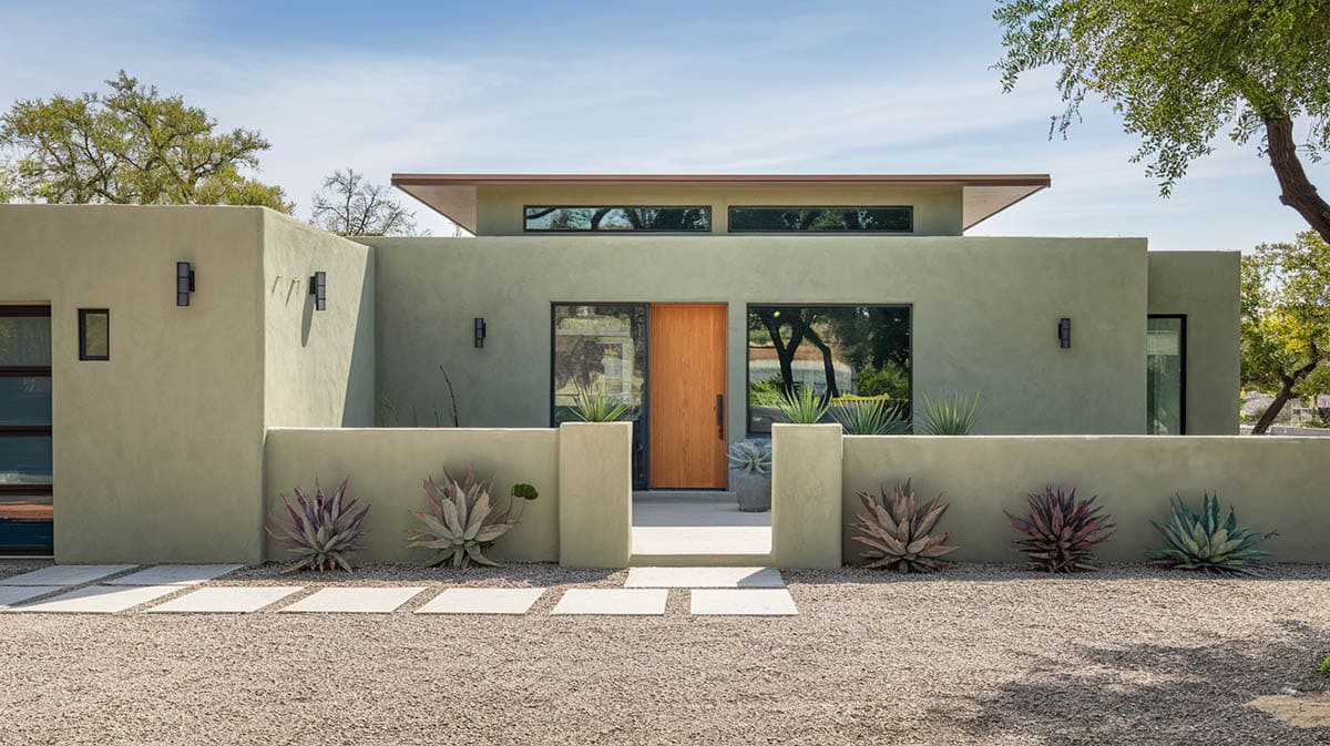 Contemporary stucco home with muted sage green exterior