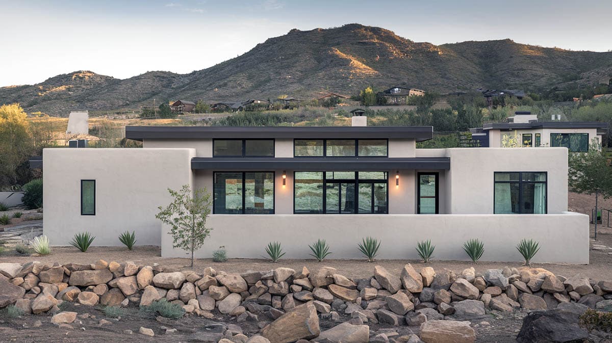 Stucco house with light gray exterior and dark charcoal roof