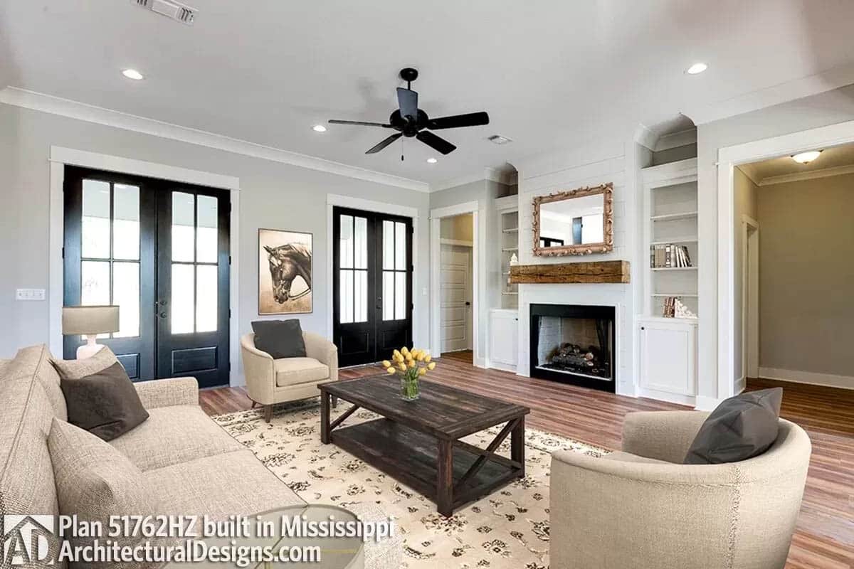 Farmhouse great room with built-ins and ceiling fan