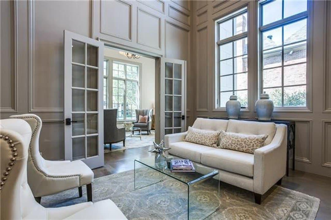 Home office with elegant wall paneling and french doors