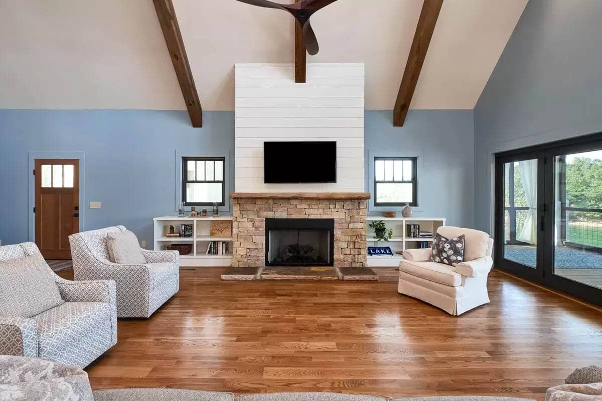 Living room with lake views and plank fireplace