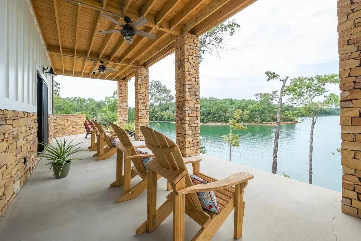 Covered patio overlooking the water with adirondack chairs