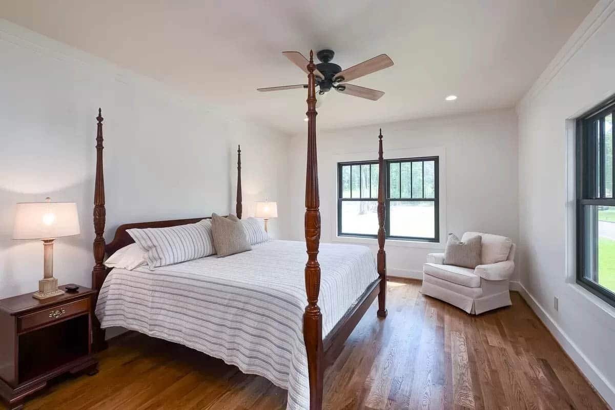 Master bedroom with wood plank floors and views of the lake